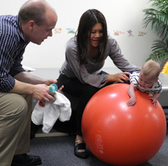 Infant performing neck exercises on a swiss ball