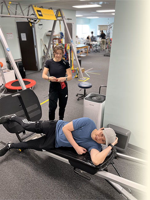 Client performing total gym exercise